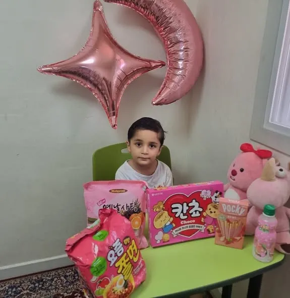 Nursery children dressed in pink.