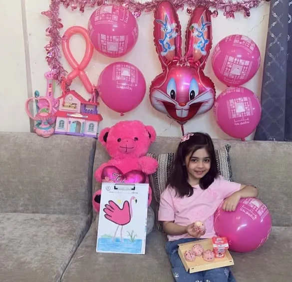 Nursery children dressed in pink.
