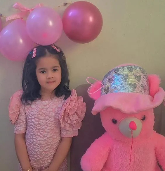 Nursery children dressed in pink.
