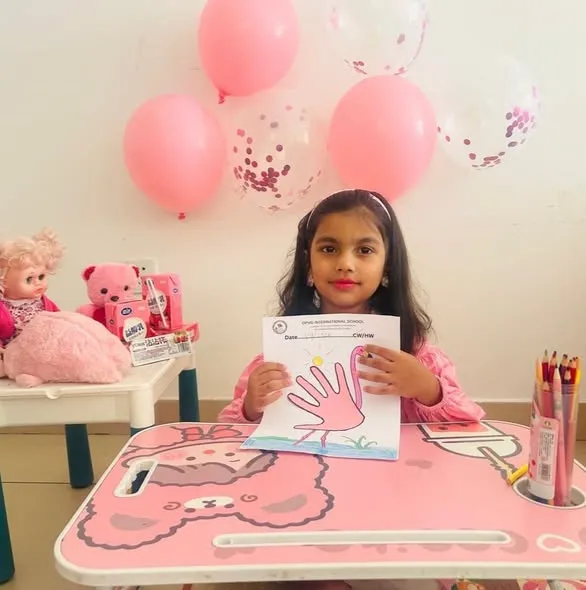 Nursery children dressed in pink.